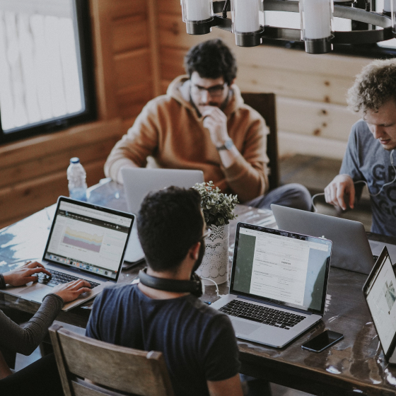 Four employees are working in a table